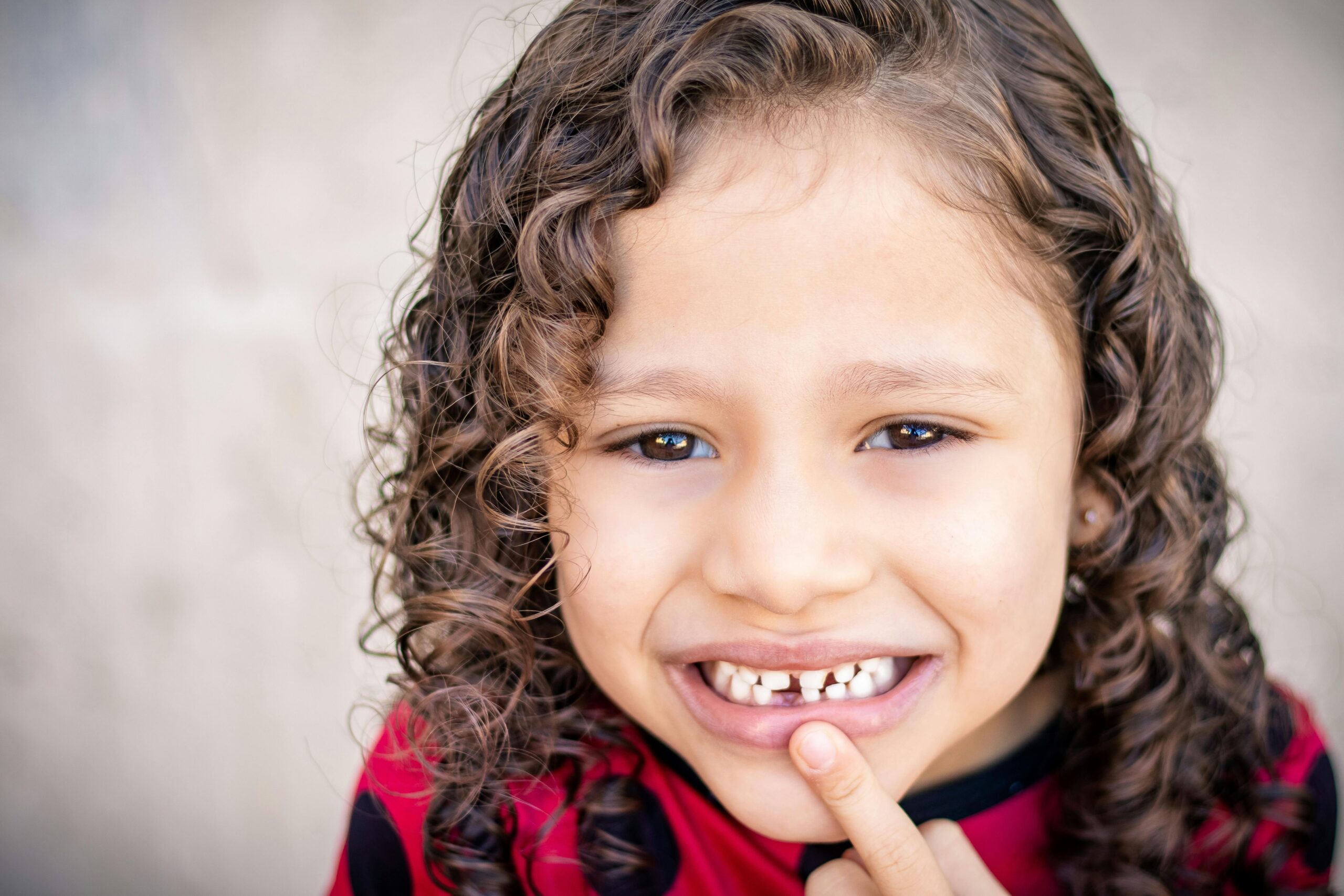 Child smiling with missing front tooth